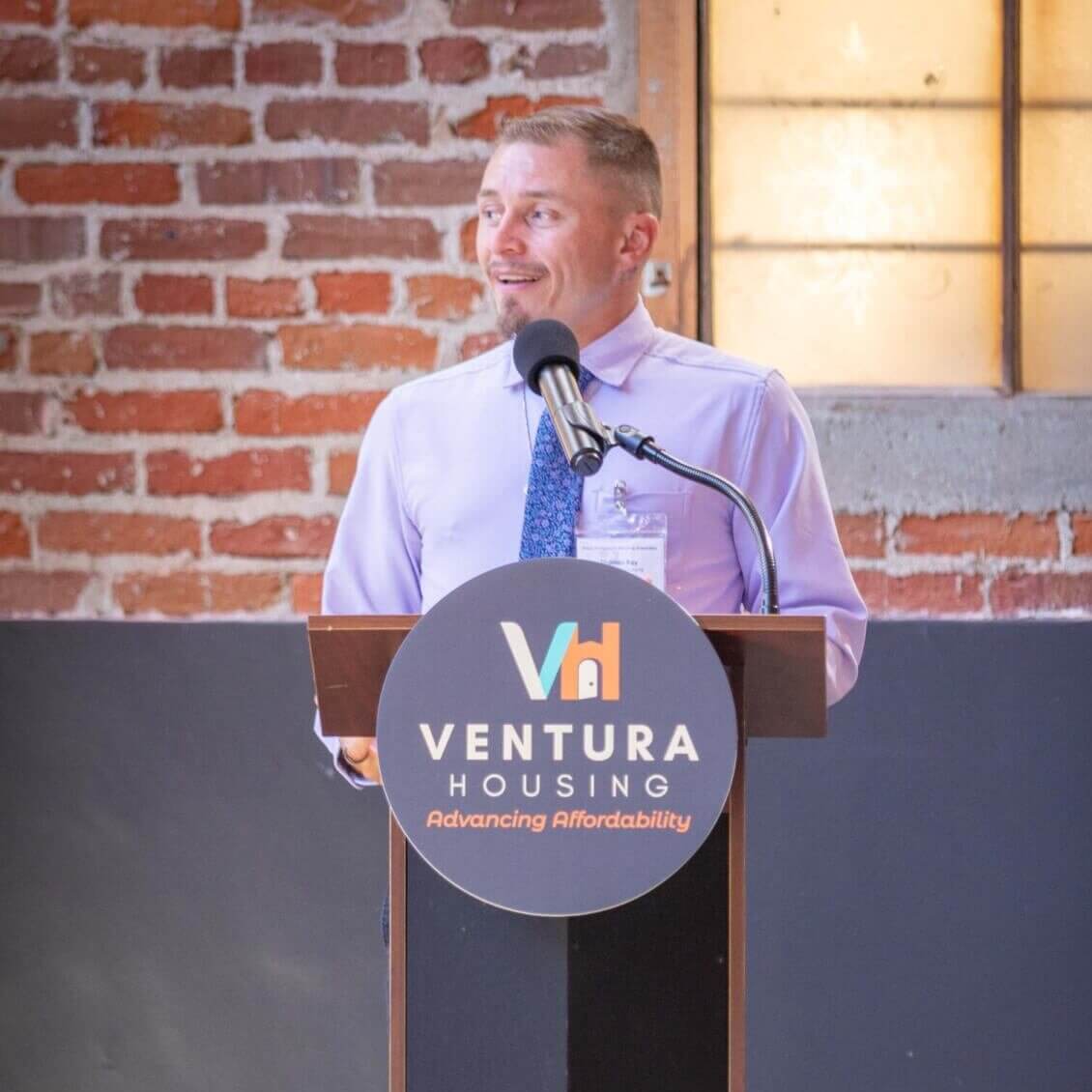 man speaking at a podium