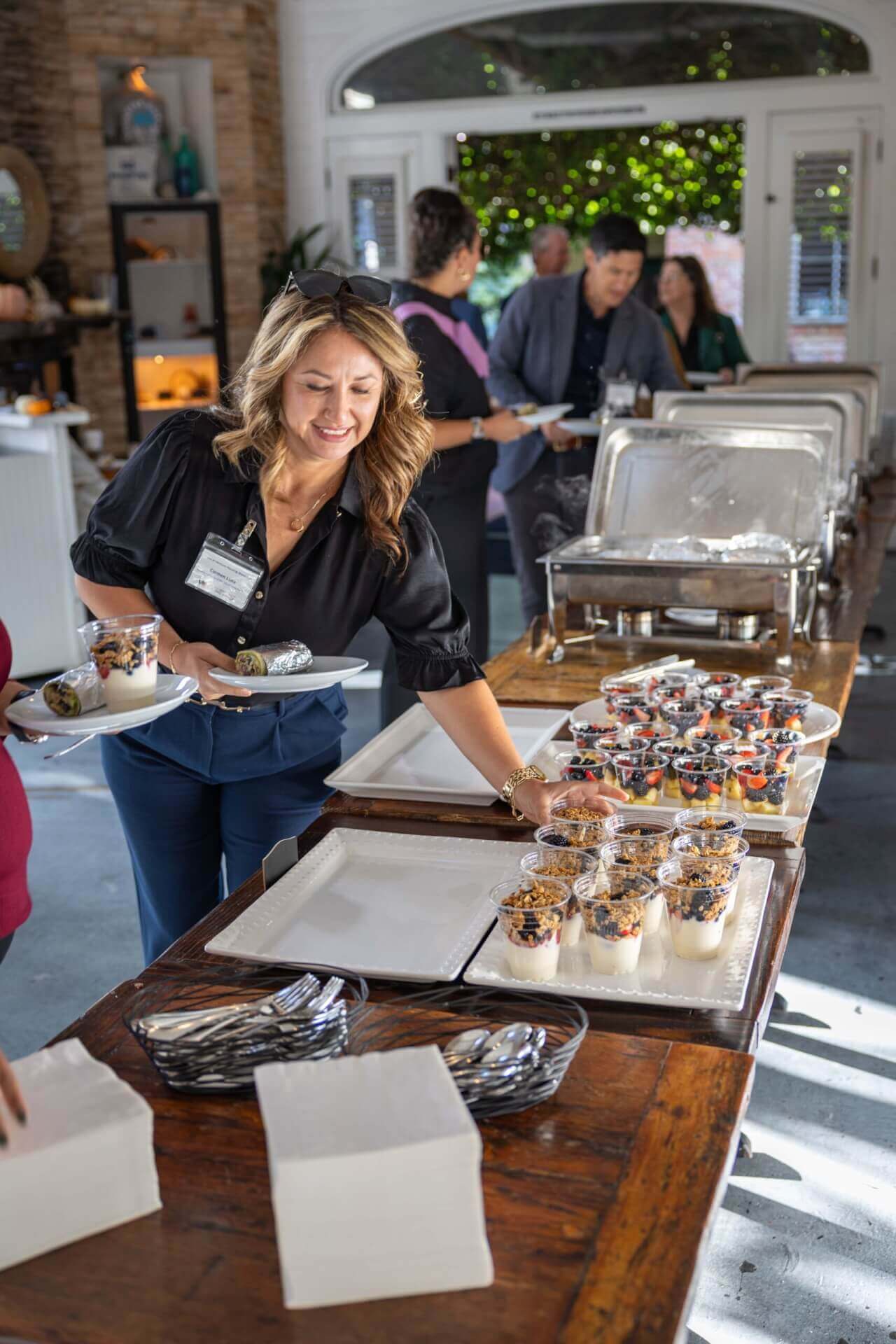 woman getting food at the event's buffet