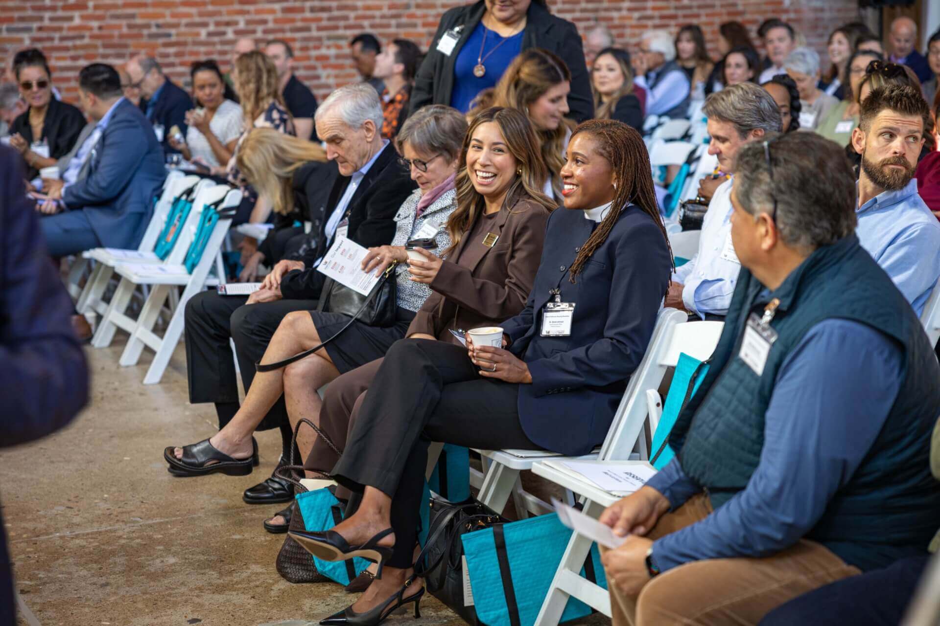 people sitting in the audience and smiling